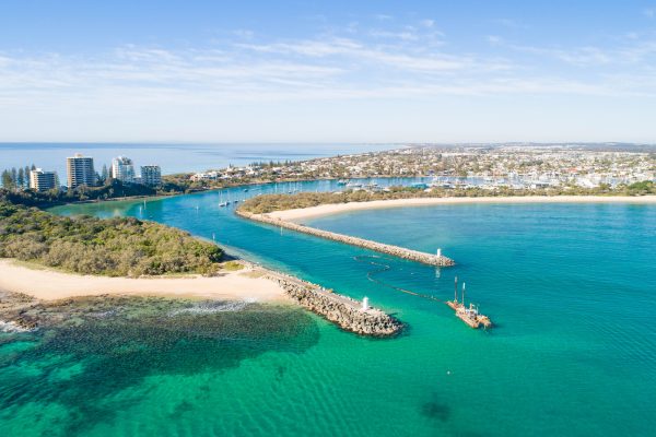 Beautiful aerial sunrise with beach, water, boats, shops and lovely holiday feel at Mooloolaba, Sunshine Coast, close to Brisbane in Queensland. Top view near Point Cartwright, river mouth and tourist